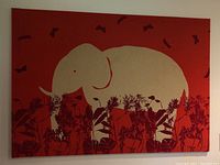 Front view of the elephant batik wall art showing elephant and floral motifs on red background