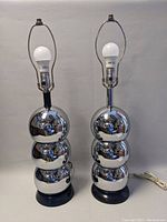 Front view of both chrome table lamps with bulbs installed