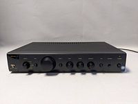 Front view of Arcam Alpha 7R amplifier showing the full control panel and brand logo.