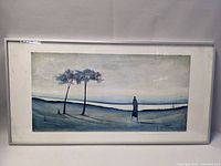 Framed painting on board showing the entire artwork and frame with two trees and a figure in a muted blue landscape.