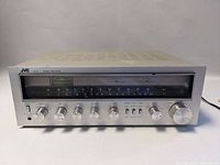 Front view of JVC R-S5 stereo receiver showing tuning dial, control knobs, and power switch.