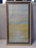 Framed abstract landscape print negotiating muted horizontal bands of color.