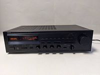 Front view of Yamaha RX-330 showing its digital display tuned to 91.1 MHz FM station and various control knobs and buttons.