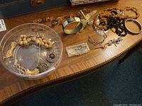 Full lot overview with assortment laid out on wood surface and clear plastic container