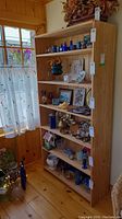 Front view of tall wood display shelving unit filled with decorative items.
