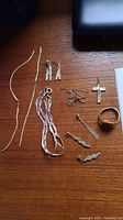 Overview of assorted jewelry pieces on wood surface