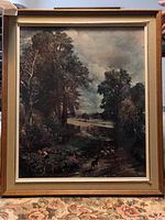 Full view of the framed art print showing the overall landscape scene with trees, river, and a dog.