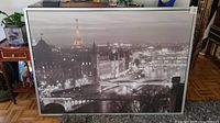 Full view of the framed print showing the Paris cityscape with the Eiffel Tower glowing in color among grayscale surroundings.