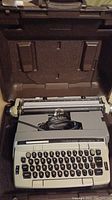 Eaton Viking electric typewriter inside carrying case showing keyboard and mechanism.