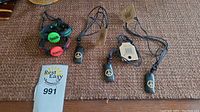 Six Wild Tribe jewelry items displayed on a textured surface: four necklaces with black peace sign pendants and two multi-strand black leather bracelets with colorful 'Peace' inscribed beads.