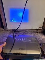 Epson projector turned on and connected showing blue screen with status info