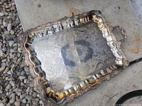 Top view of the large rectangular silver plated serving tray showing embossed decorative patterns and scalloped edges.