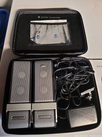 Altec Lansing travel computer speakers, power adapter, and carrying case shown inside the open case.