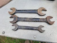 Three Canadian made double open-end wrenches with Shelley branding and varying sizes visible. Black painted finish with rust spots.