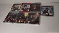 Photo showing all seven PS3 game cases arranged in two rows.