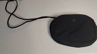 Front view of small black Lululemon purse with visible logo and strap.