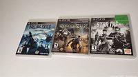Photo of three PS3 games: Falling Skies, Starhawk, and Star Trek, all in original cases showing cover art.