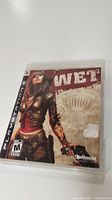 PlayStation 3 game case of 'Wet' showing cover art with female character and title.