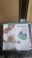 Front of box showing the body relaxer device and a model demonstrating use on the stomach area.