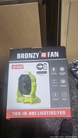 Front view of Bronzy X20 box showing product image and branding, indicating a two-in-one lighting and fan device.
