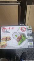Front view of the Starfrit Deli Slicer box showing the product image and basic features.