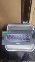 Photo of the Logitech MX Keys Mini wireless keyboard in unopened box, showing front label and packaging design.