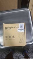 Box with printed label 'Professional Live Stream' showing icons for warm, beauty, and fill-in light modes.