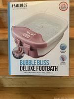 Boxed Homedics Deluxe Bubble Bliss Footbath showing product image and features such as invigorating bubbles and 3 massage attachments for foot massage.