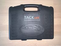 Closed black TACKLIFE carrying case with handle and logo.