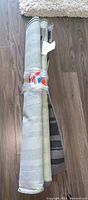Two rolled IKEA IBSTED rugs, one roll showing label and color pattern.