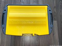 Top view showing the yellow lid with embossed 'Igloo Pro Pack Master' label and a built-in ruler.