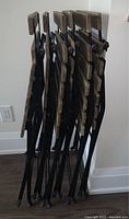 Side view of six foldable chairs stacked together.