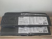 Three Ikea SKUBB storage sets, wrapped in plastic packaging, laid flat on a white surface.