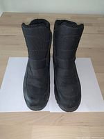 Front view of black men's winter boots showing overall shape and condition.