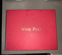 Red box labeled 'WINE PULL' in gold lettering showing the product packaging.