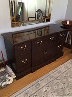 Full front view of mahogany sideboard beneath mirror