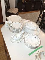 Full set displayed on a table with all plates, bowls, and serving pieces visible.