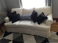Front view of 3-seater sofa with all five throw cushions displayed