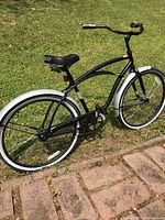 Side view of the black Huffy Santa Fe cruiser bike showing the general condition, frame and tires