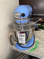 Front view of sky blue KitchenAid Artisan stand mixer assembled on countertop