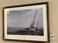 Full front view of framed print showing sailing boat on ocean with bronze accent frame corners.