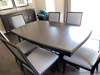Top view of table with leaf installed, surrounded by chairs