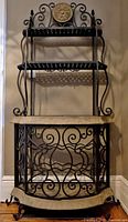 Full view of the Bonbay Varendah wine rack showing wrought iron scroll design, beveled glass top, faux-stone shelves and curved wine bottle storage