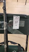 Close-up of fishing chair with lot label 'Fishing Rods lot C'.