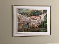 Frontal view of framed serigraph artwork showing detailed image of a person resting in a hammock amidst garden setting.