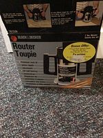 Original box of Black & Decker Router Toupie showing product branding and key features with bonus offer sticker for bit set.