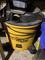 Front view of yellow DirtHound wet/dry vacuum showing the brand name and general condition.