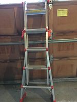 Ladder in A-frame configuration leaning against garage door