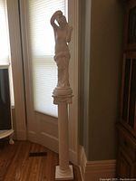 Full view of the statue on the pedestal stand, showing height and proportions.