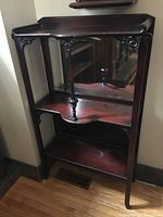 Front view of the Victorian wooden shelf with mirror back, showing two shelves, ornate column, and decorative woodwork.